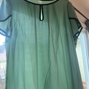 Stylish green top trimmed with black piping